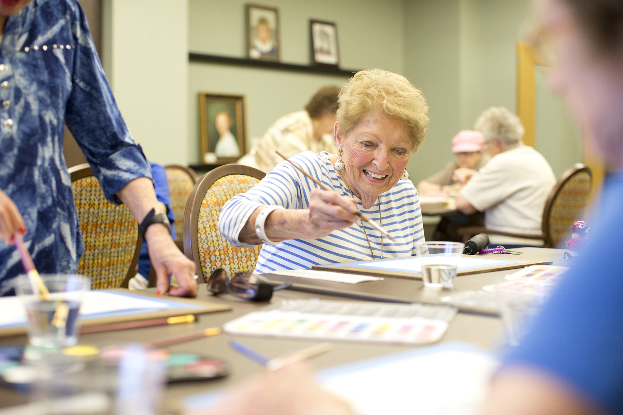 Women painting in the arts and crafts room at Kingswood Senior Living Located in Kansas City, MO.
