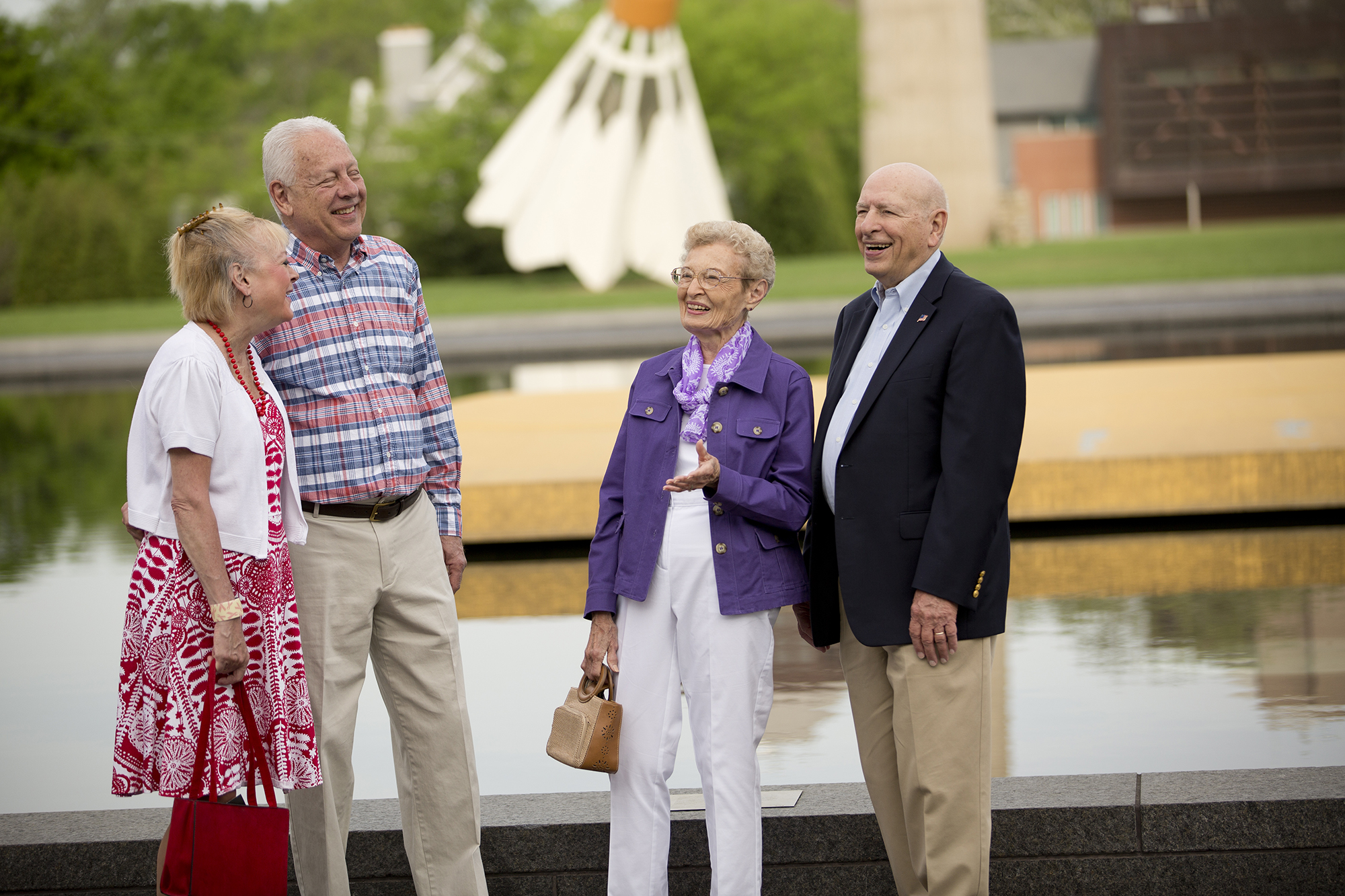 Two couples laughing while on the grounds of the Nelson Museum in Kansas City, MO