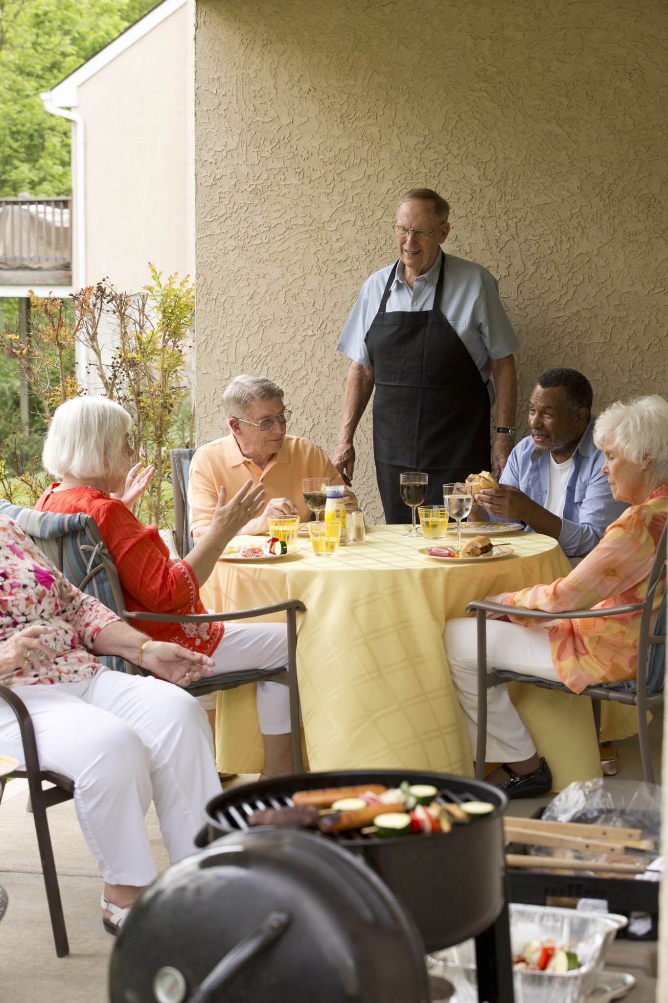 Two couples enjoying dinner at Kingswood Senior Living Located in Kansas City, MO.