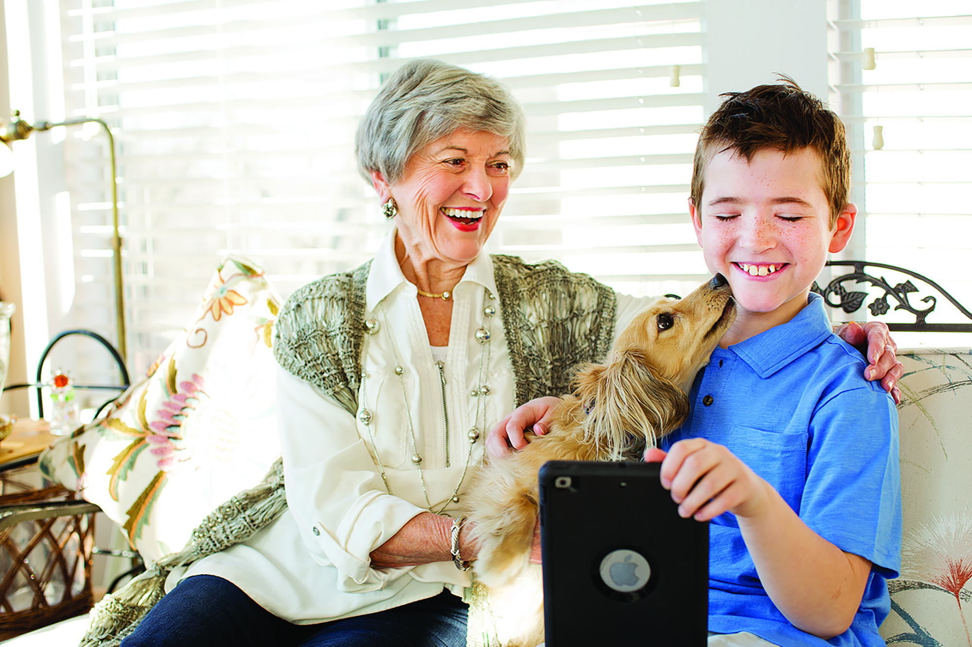 A women and boy looking at an iPad.