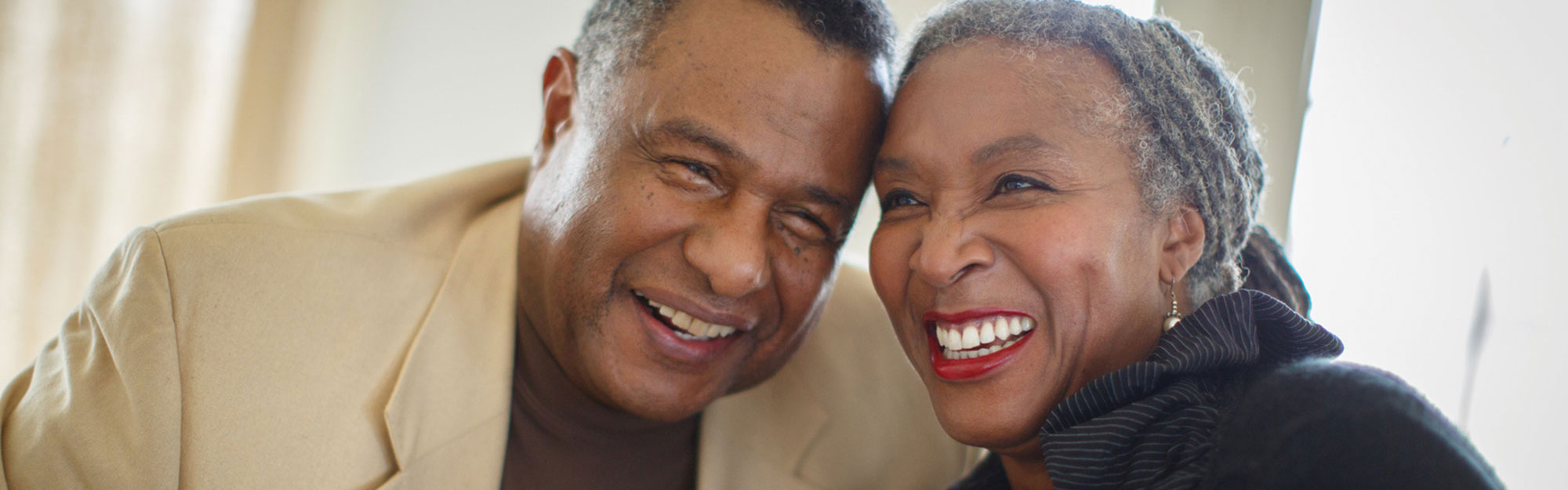 A couple in a apartment smiling at Kingswood Senior Living Located in Kansas City, MO.