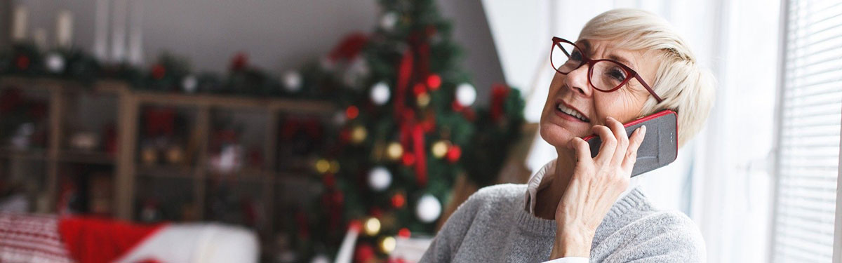 A women talking on the phone in her apartment at Kingswood Senior Living Located in Kansas City, MO.