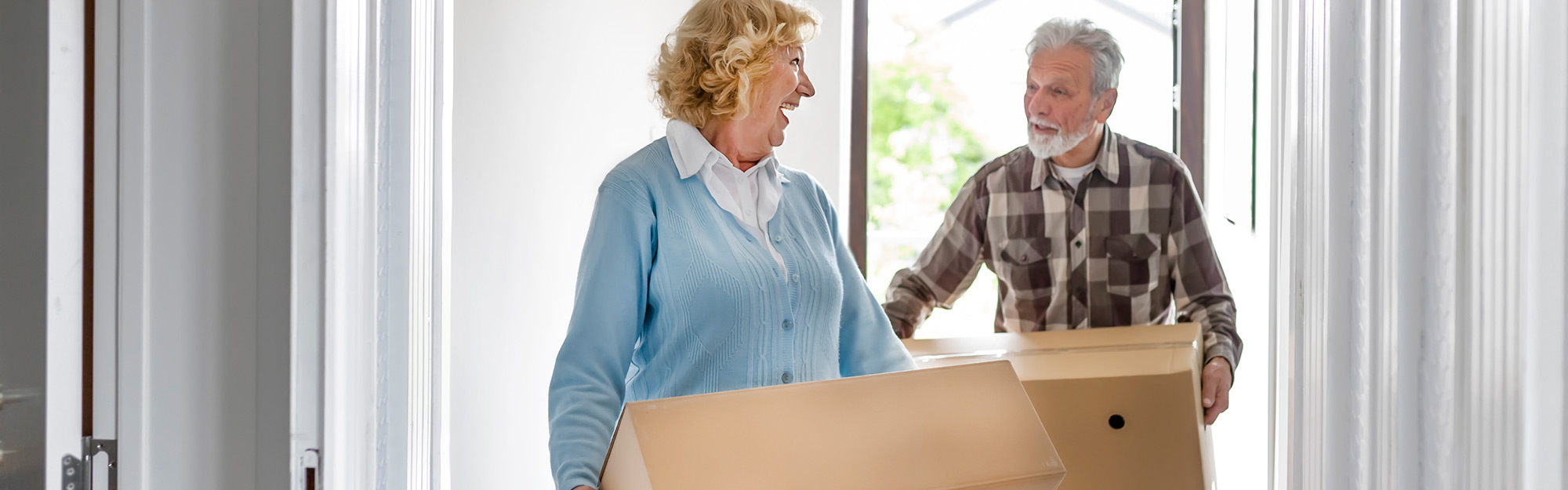 Senior couple packing moving boxes