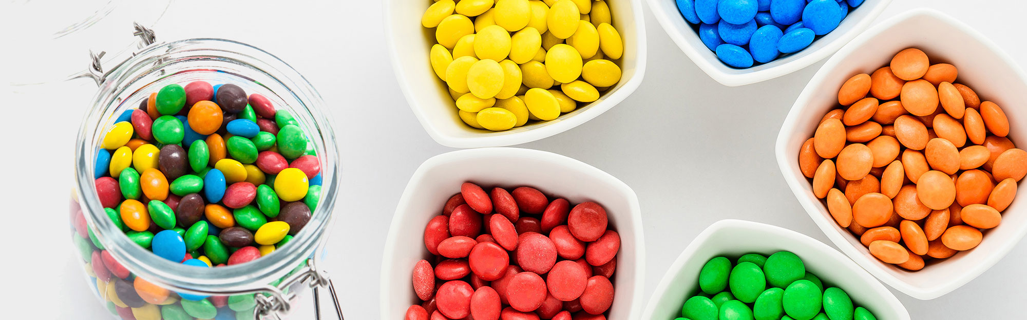 Colorful collection of candies in jars and bowls