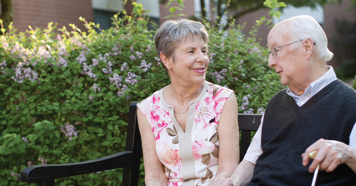 couple talking on a bench